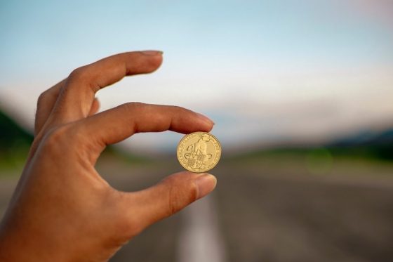 Holding up an old gold coin